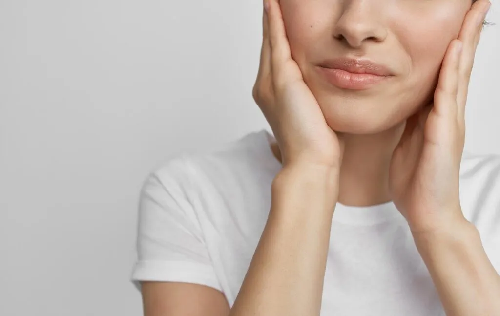 Woman with both hands on each cheek